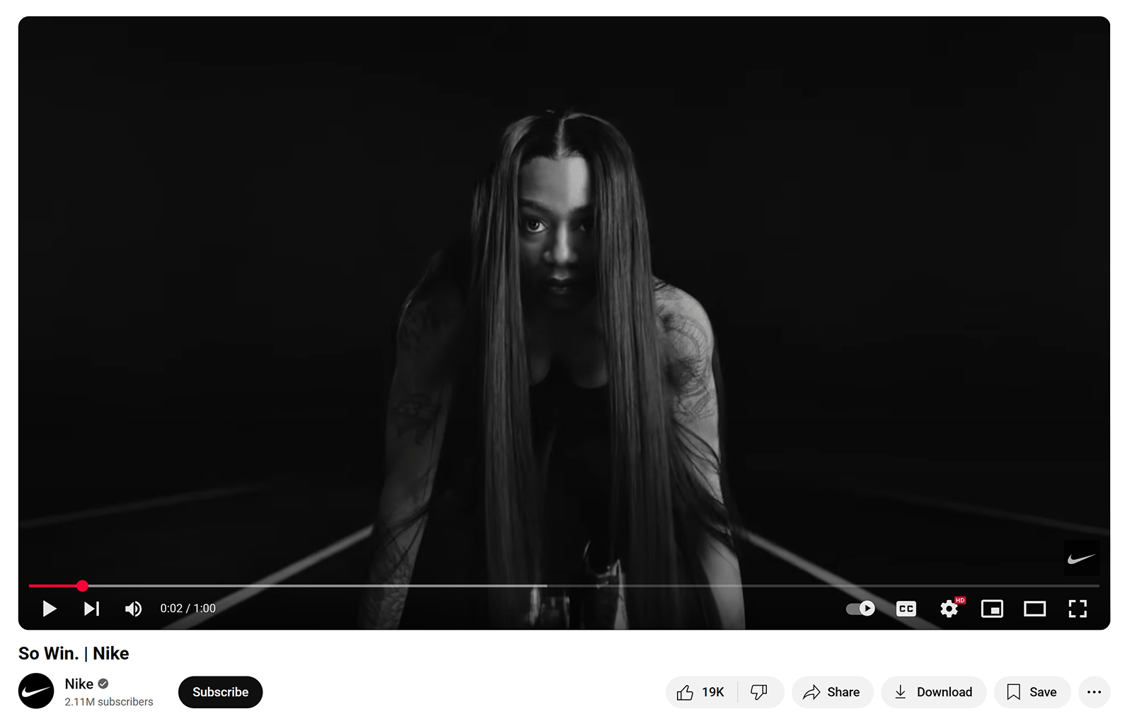 Screenshot from Nike's "So Win" video showing a female athlete in starting position on a track, in black and white.